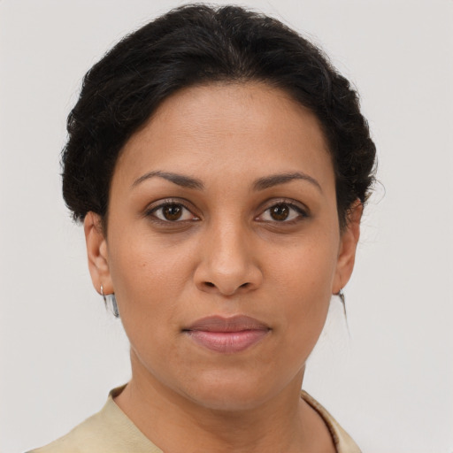 Joyful latino young-adult female with short  brown hair and brown eyes
