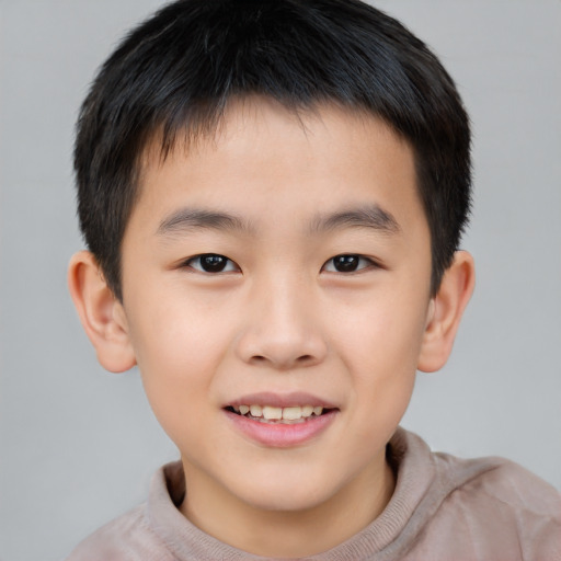 Joyful asian child male with short  brown hair and brown eyes