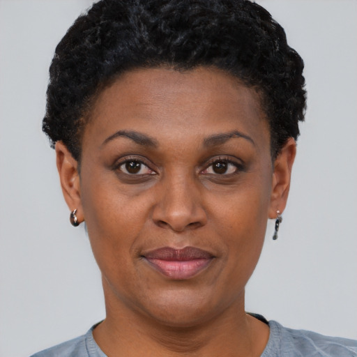 Joyful black young-adult female with short  brown hair and brown eyes