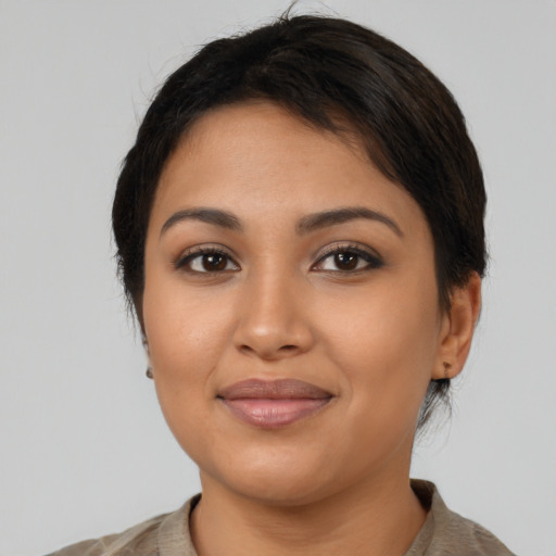 Joyful latino young-adult female with medium  black hair and brown eyes