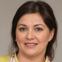 Joyful white adult female with medium  brown hair and brown eyes