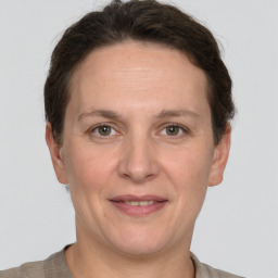 Joyful white adult female with short  brown hair and grey eyes