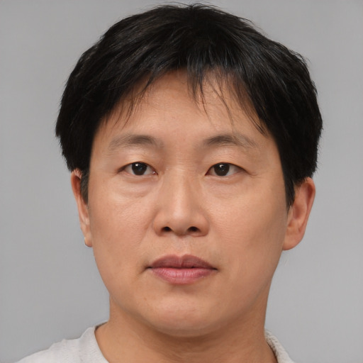 Joyful asian adult female with short  brown hair and brown eyes