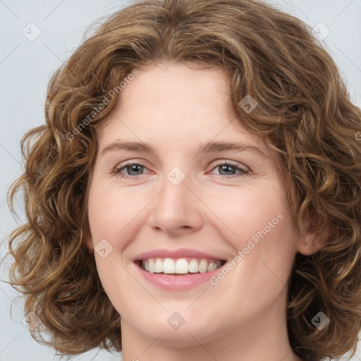 Joyful white young-adult female with medium  brown hair and green eyes