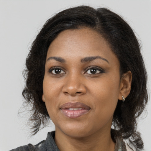 Joyful black young-adult female with medium  brown hair and brown eyes
