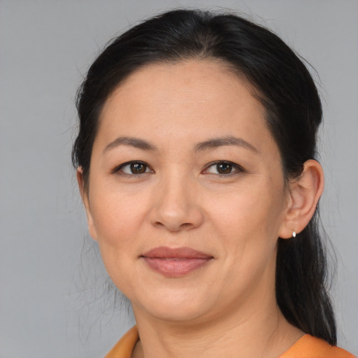 Joyful asian adult female with medium  brown hair and brown eyes