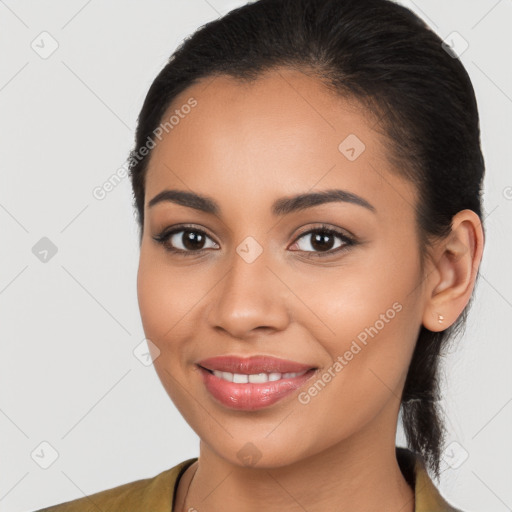 Joyful latino young-adult female with long  brown hair and brown eyes