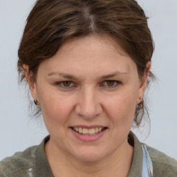 Joyful white adult female with medium  brown hair and grey eyes