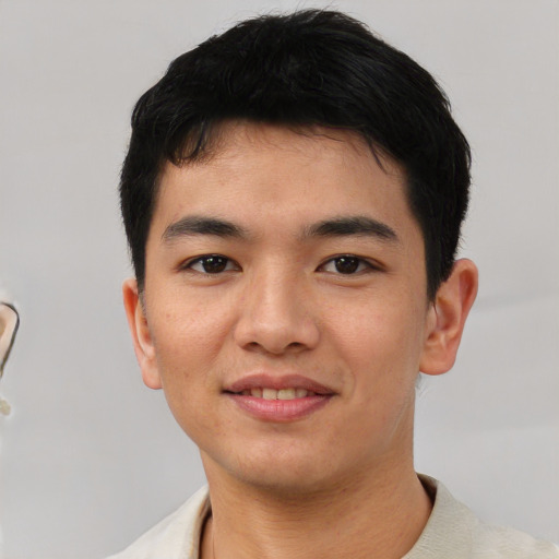 Joyful asian young-adult male with short  black hair and brown eyes