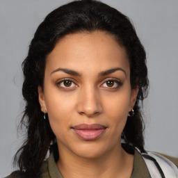 Joyful latino young-adult female with medium  brown hair and brown eyes