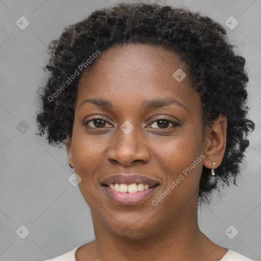 Joyful black young-adult female with short  brown hair and brown eyes