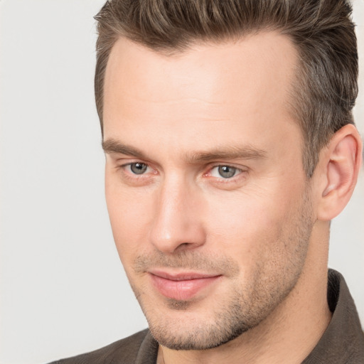 Joyful white young-adult male with short  brown hair and brown eyes