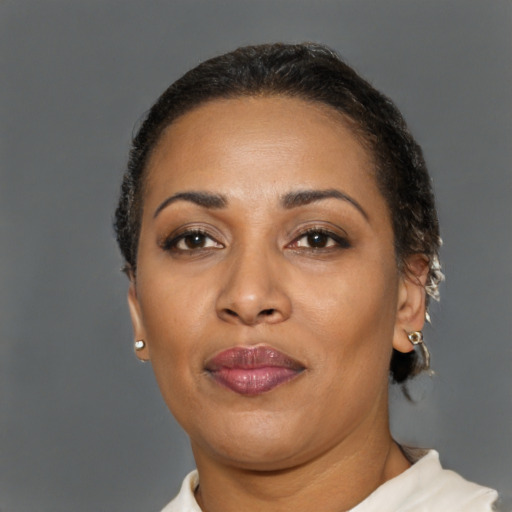 Joyful black adult female with short  brown hair and brown eyes