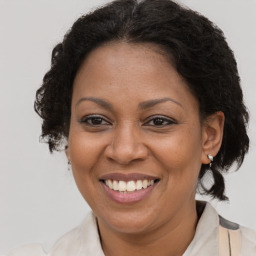 Joyful black adult female with medium  brown hair and brown eyes