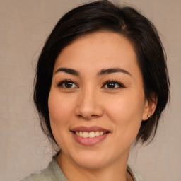 Joyful asian young-adult female with medium  brown hair and brown eyes