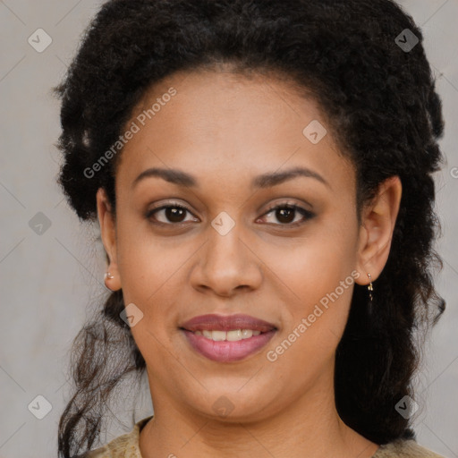 Joyful black young-adult female with medium  brown hair and brown eyes