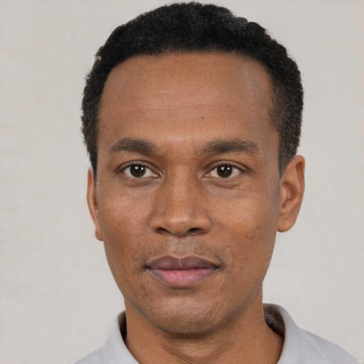 Neutral black adult male with short  black hair and brown eyes