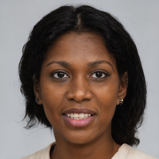 Joyful black young-adult female with medium  brown hair and brown eyes