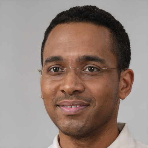 Joyful black adult male with short  black hair and brown eyes