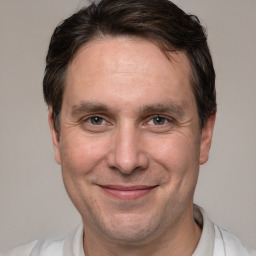 Joyful white adult male with short  brown hair and brown eyes