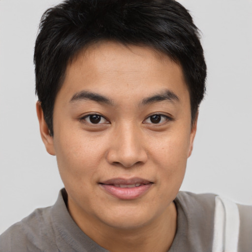 Joyful asian young-adult female with short  brown hair and brown eyes