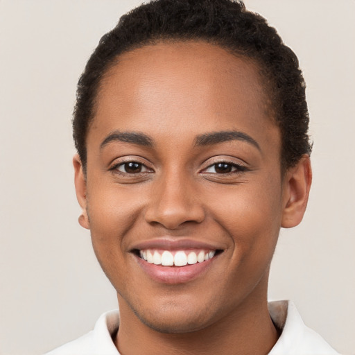 Joyful latino young-adult female with short  brown hair and brown eyes