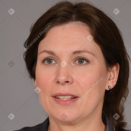 Joyful white adult female with medium  brown hair and blue eyes