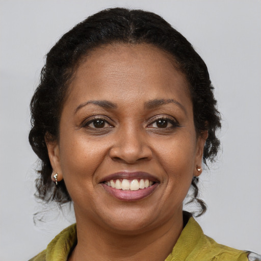 Joyful latino adult female with medium  brown hair and brown eyes
