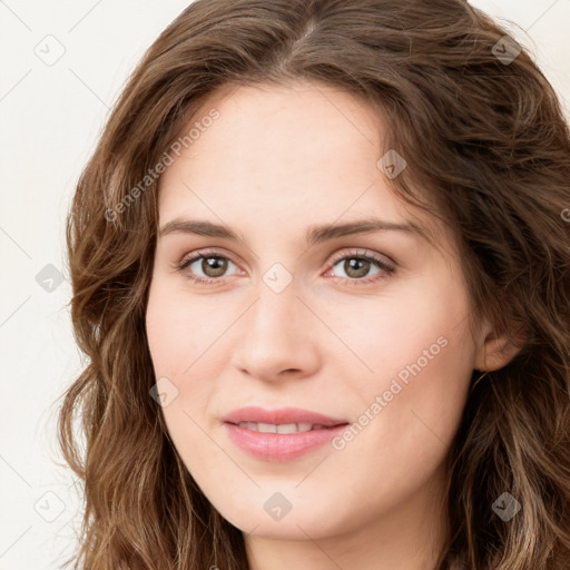 Joyful white young-adult female with long  brown hair and green eyes