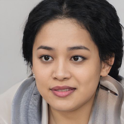 Joyful asian young-adult female with long  black hair and brown eyes