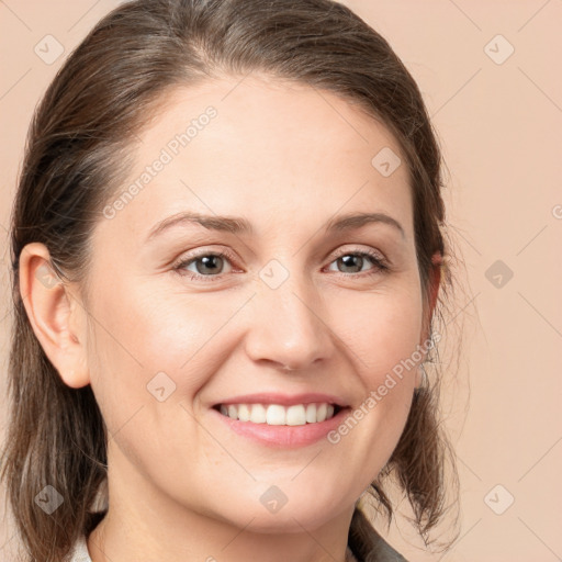 Joyful white young-adult female with medium  brown hair and grey eyes