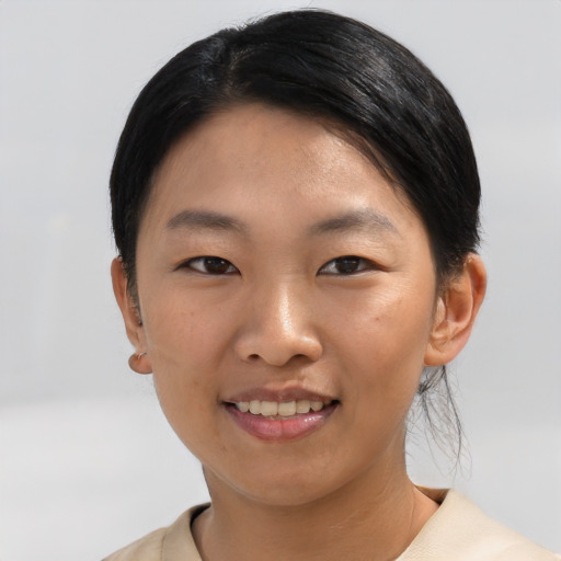 Joyful asian young-adult female with short  black hair and brown eyes