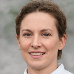 Joyful white adult female with short  brown hair and grey eyes