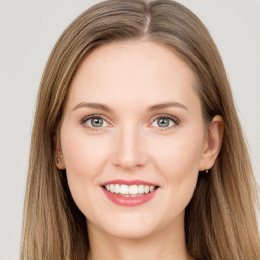 Joyful white young-adult female with long  brown hair and grey eyes