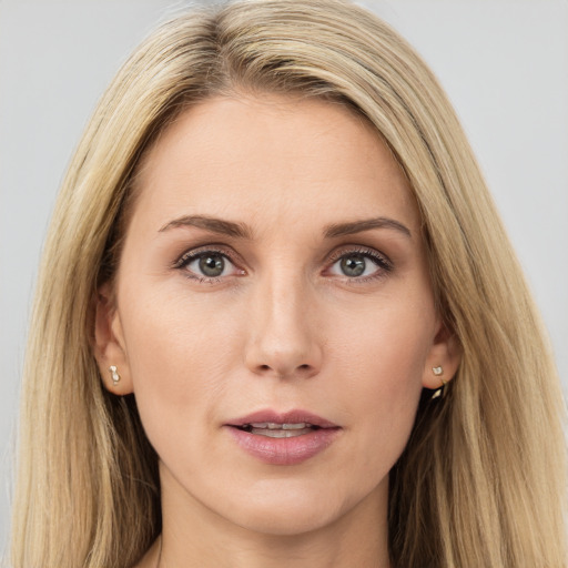 Joyful white young-adult female with long  brown hair and green eyes