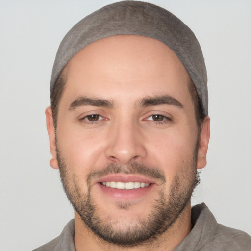 Joyful white young-adult male with short  black hair and brown eyes