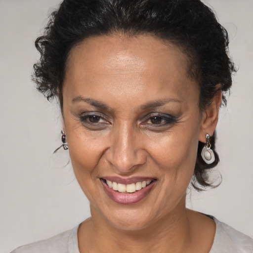 Joyful black adult female with medium  brown hair and brown eyes