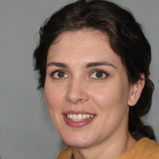 Joyful white young-adult female with medium  brown hair and brown eyes