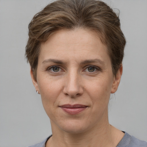 Joyful white adult female with short  brown hair and grey eyes