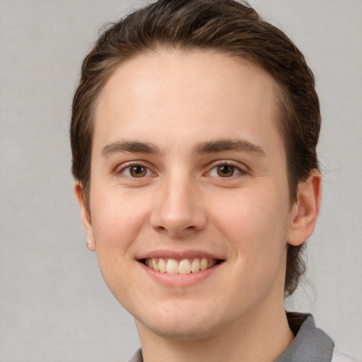 Joyful white young-adult female with short  brown hair and grey eyes