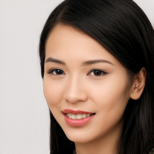 Joyful white young-adult female with long  black hair and brown eyes