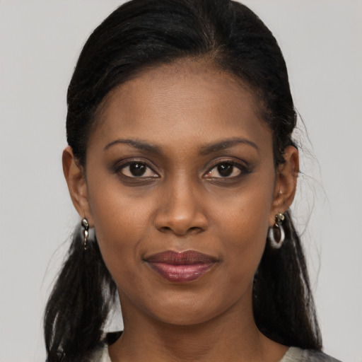 Joyful black young-adult female with medium  black hair and brown eyes
