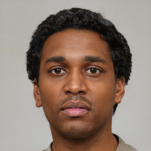 Neutral black young-adult male with short  black hair and brown eyes