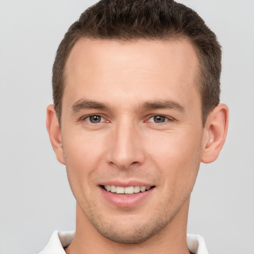 Joyful white young-adult male with short  brown hair and brown eyes