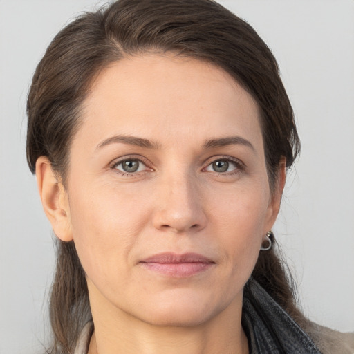 Joyful white adult female with medium  brown hair and brown eyes