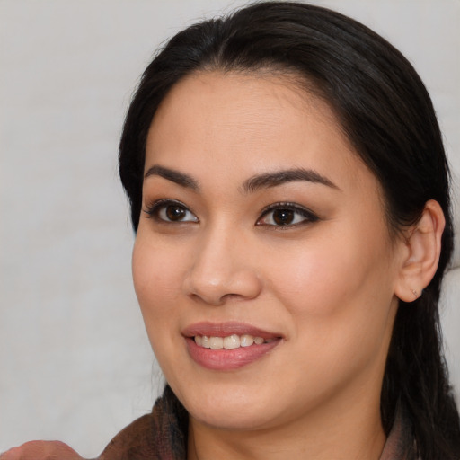 Joyful asian young-adult female with medium  brown hair and brown eyes