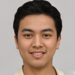 Joyful asian young-adult male with short  black hair and brown eyes