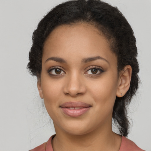 Joyful latino young-adult female with long  brown hair and brown eyes