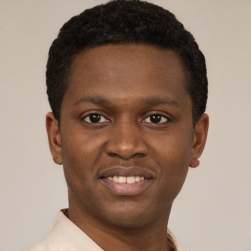 Joyful black young-adult male with short  brown hair and brown eyes