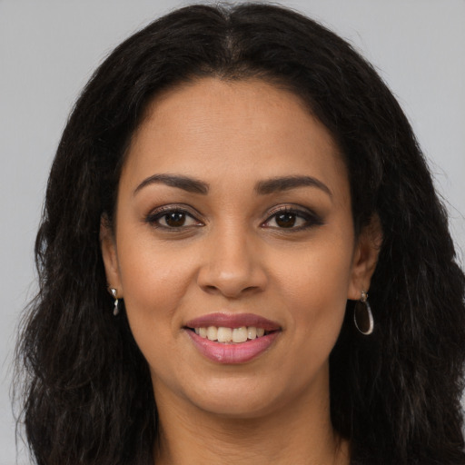 Joyful latino young-adult female with long  brown hair and brown eyes